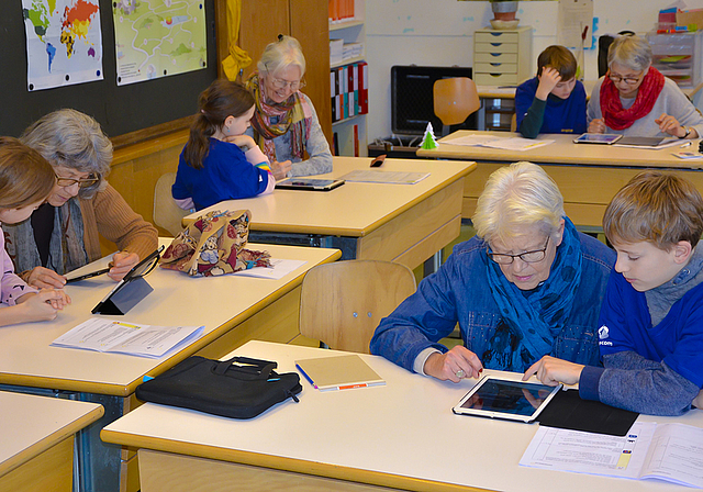 Die digitale Welt kennenlernen: Jung und Alt beugten sich im Arlesheimer Dom-Schulhaus über iPads, um gemeinsam dessen Geheimnisse zu erkunden.  Foto: Thomas Immoos