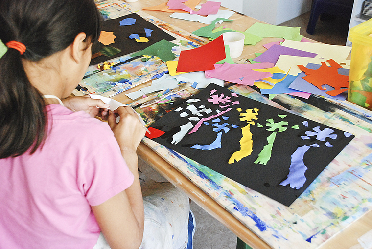 Erinnert irgendwie doch an Matisse: Junge Künstlerin beim Collagieren.  Foto: Thomas Brunnschweiler