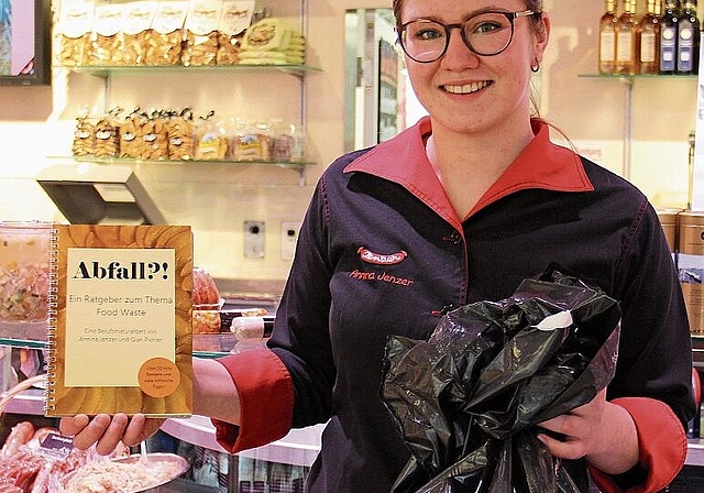 Spezialitäten gegen Food Waste: Annina Jenzer mit Ratgeber und «symbolischem Abfallsack». Foto: Tobias Gfeller